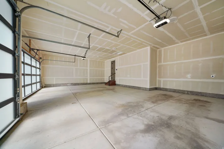 Overhead garage door with frosted glass panels and black framing
