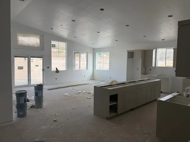 Vaulted ceiling with recessed lighting, multiple windows, kitchen island cabinetry with storage, perimeter kitchen cabinetry