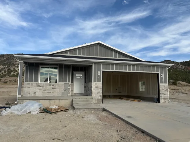 Exterior featuring vertical siding and stone veneer accents