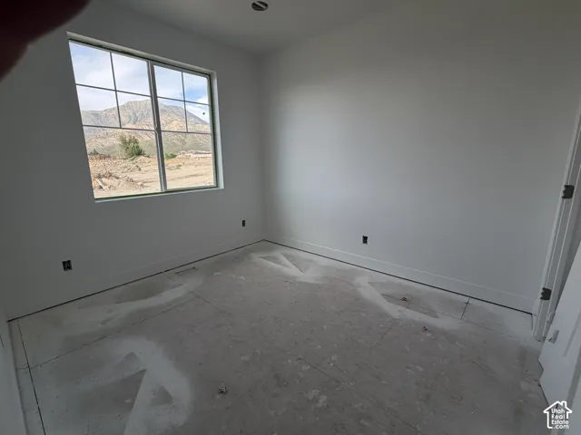 Large window with muntins and mountain scenery, white walls, and a ceiling light fixture