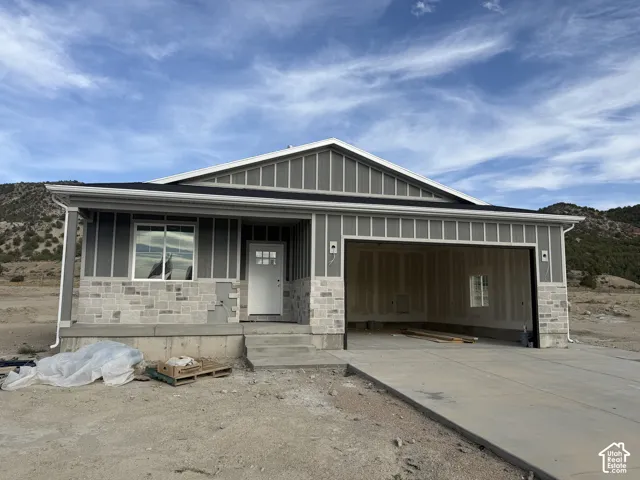 Exterior featuring vertical siding and stone veneer accents