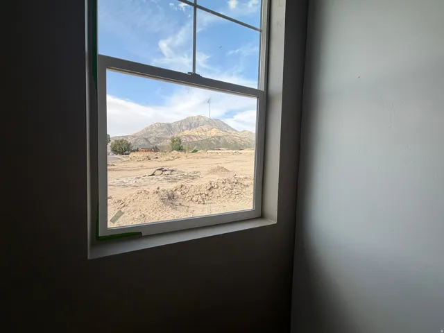 White-framed window showcasing distant mountain scenery