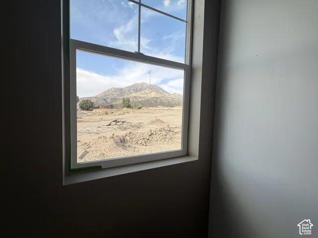 White-framed window showcasing distant mountain scenery