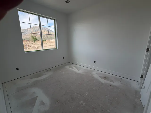 Large window with muntins and mountain scenery, white walls, and a ceiling light fixture