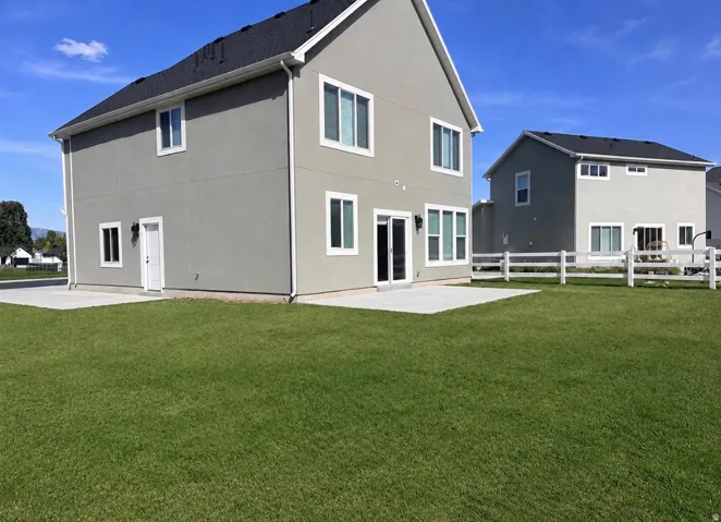 Expansive green lawn with a white post-and-rail fence
