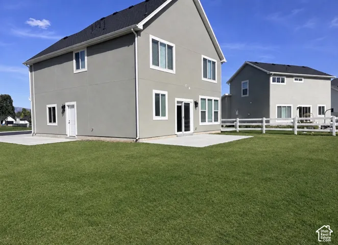Expansive green lawn with a white post-and-rail fence