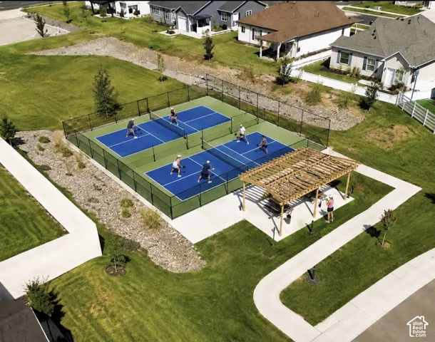 Two pickleball courts with black perimeter fencing