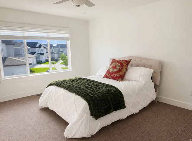 Expansive window with white blinds, neutral wall paint, ceiling fan, recessed lighting, and brown carpet flooring