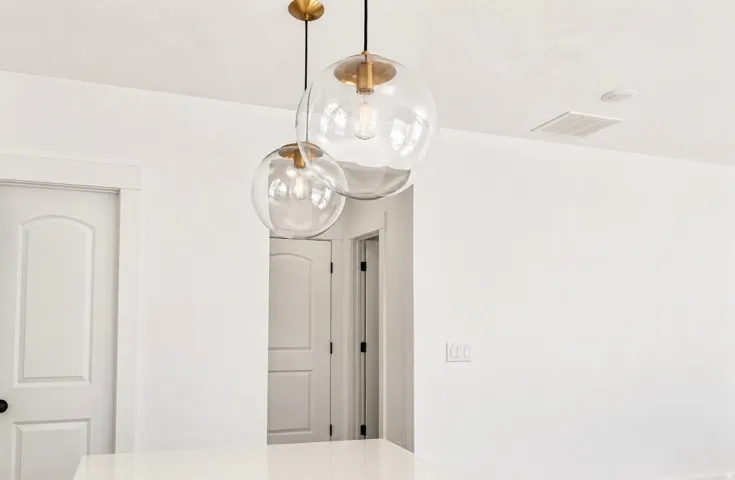 Modern pendant lighting with clear glass globes and brass accents