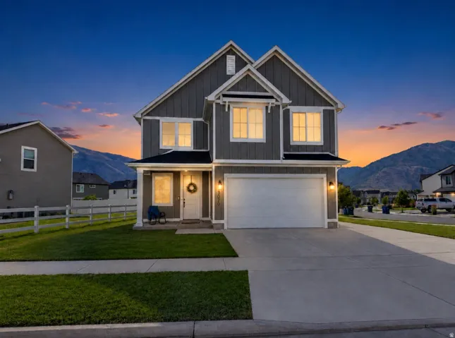Two-story residence with neutral greige siding and white trim