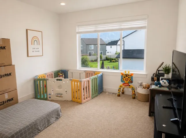 Spacious room with recessed lighting, large window with blinds, and neutral carpet flooring