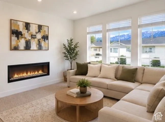 Linear built-in fireplace with a matte black surround, large windows with mountain and neighborhood scenery, and recessed ceiling lighting