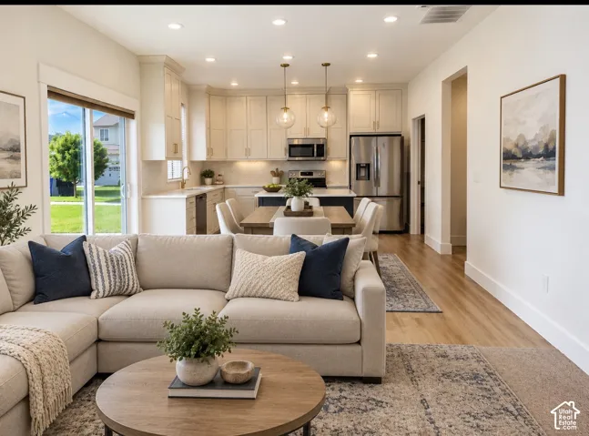 Kitchen featuring shaker-style cabinetry, stainless steel appliances, a center island, recessed lighting, and wood-finish flooring