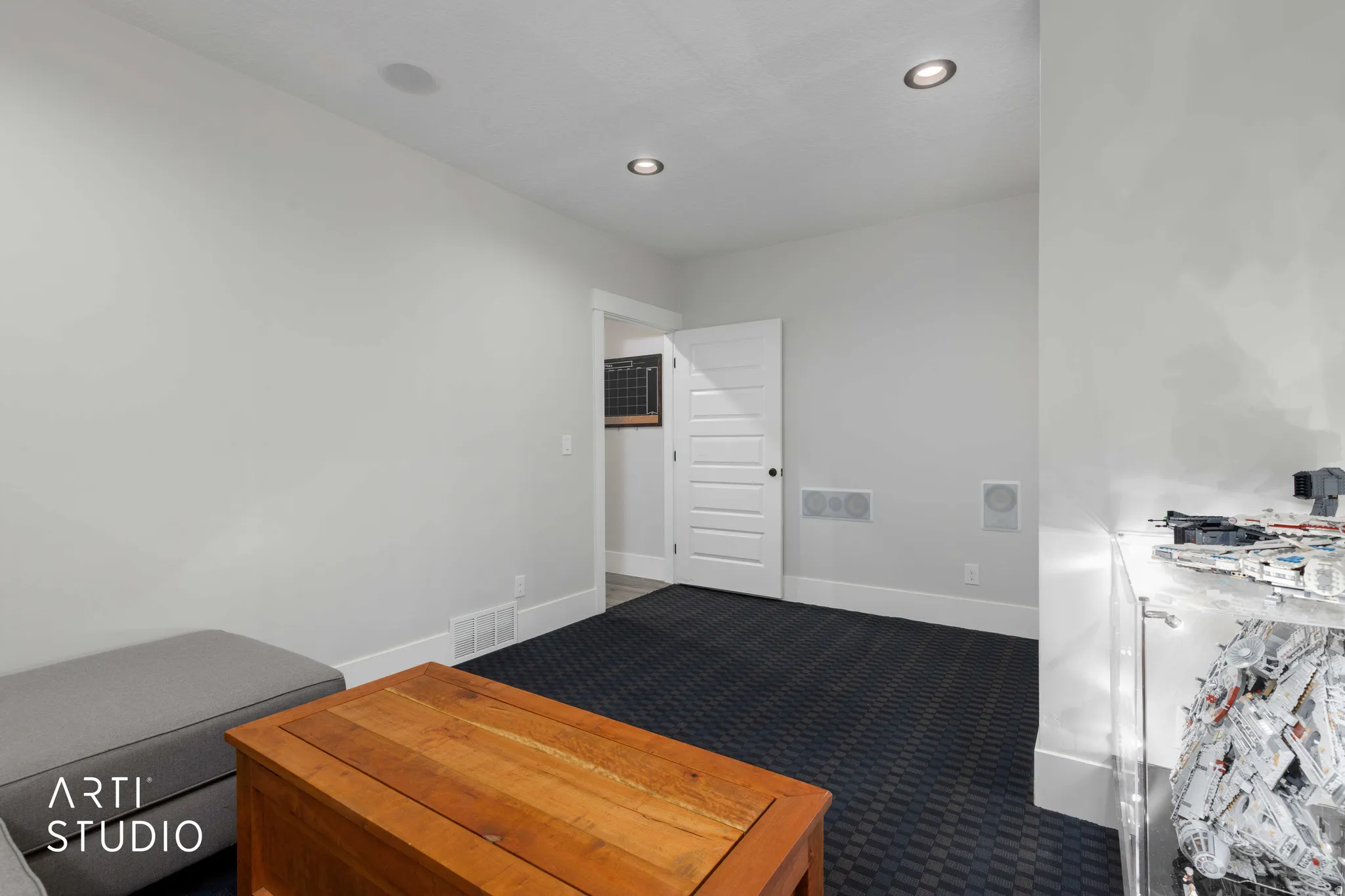 Recessed ceiling lighting, in-ceiling audio speakers, and white trim work