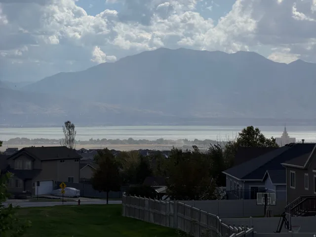 Expansive mountain and water scenery with a residential backdrop