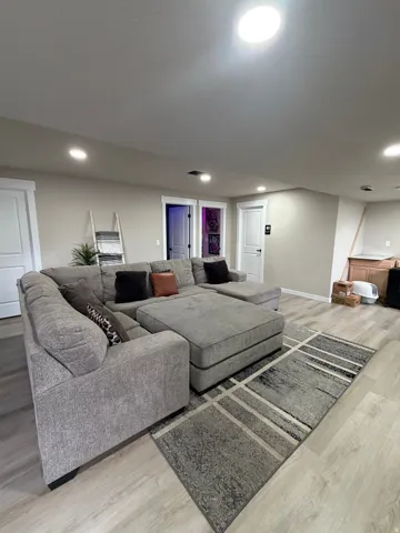 Recessed lighting and a central ceiling fixture illuminate the space
