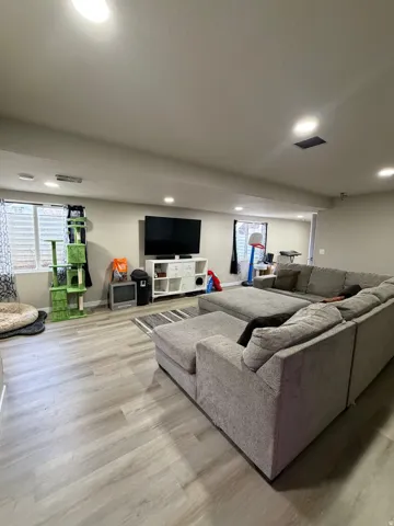 Recessed lighting and wood-finish flooring with neutral wall tones