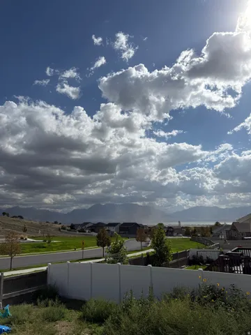 Expansive mountain scenery with a distant body of water