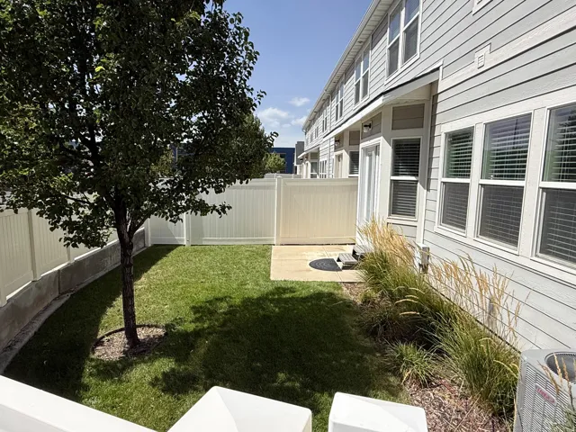 Private, fully fenced backyard area featuring a manicured lawn