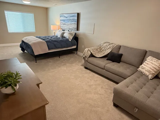 Carpeted flooring, recessed lighting, and a window with blinds