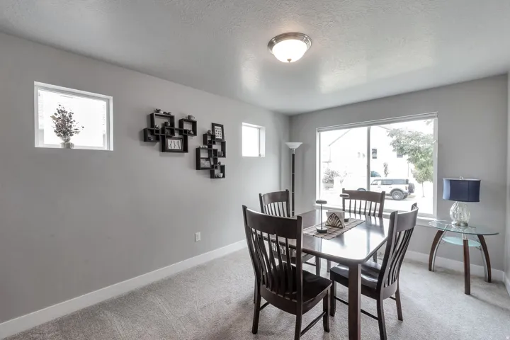 Recessed lighting and multiple windows illuminate this carpeted room