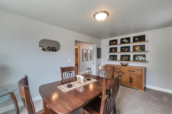 Built-in shelving with integrated lighting, wood-finish console cabinetry, and an overhead flush mount fixture