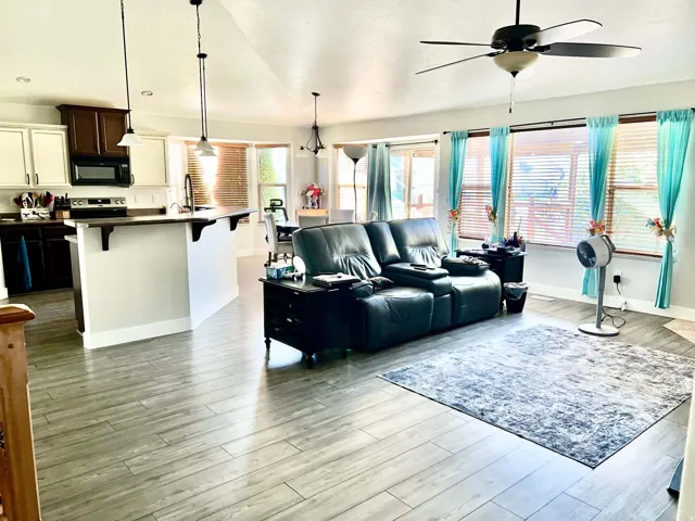 Open-concept living area with wood-finish flooring