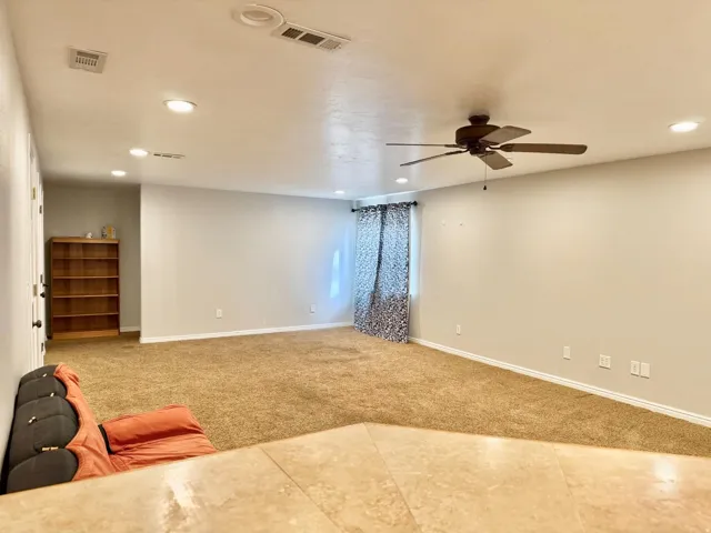 Recessed lighting, ceiling fan, neutral wall paint, carpeted flooring, tiled floor entryway