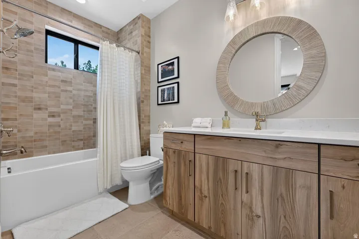 Wood-finish vanity with a white countertop and undermount sink