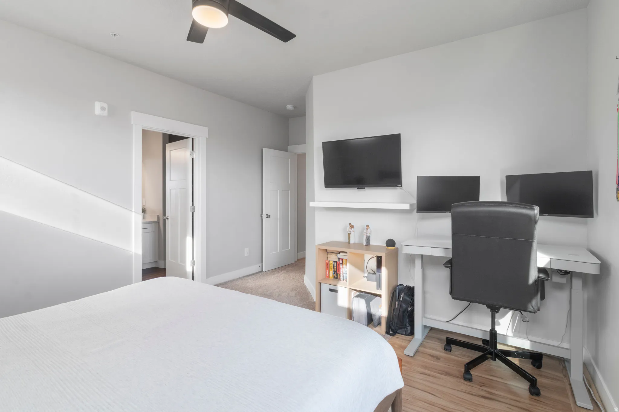 Recessed lighting, wood-finish flooring, ceiling fan, white trim, and white doors