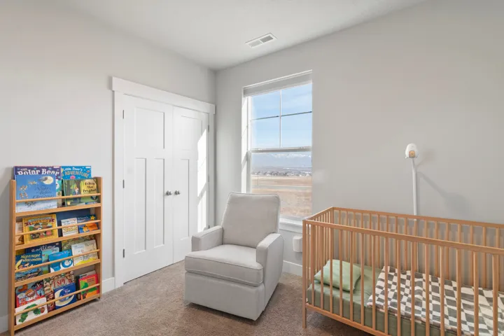 Light gray wall paint with white trim, double panel doors, and a large window with mountain scenery