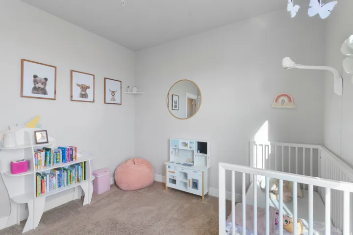 Plush carpeting, light wall tones, and bright natural light create an inviting atmosphere