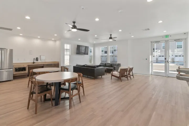 Recessed lighting, wood-finish flooring, built-in cabinetry, stainless steel appliances, and ceiling fans