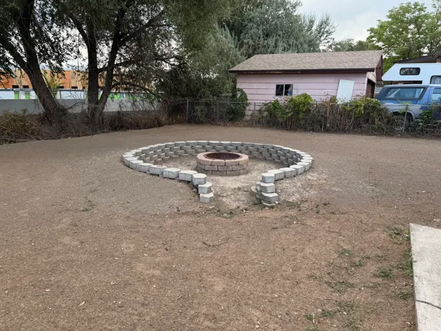 Hardscaped fire pit area with paver block seating