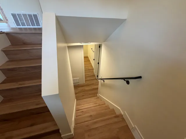 Wood-finish flooring throughout stairwell and hallway
