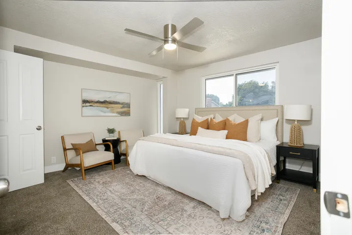 Recessed lighting, ceiling fan, white paneled door, horizontal windows, and gray carpet flooring