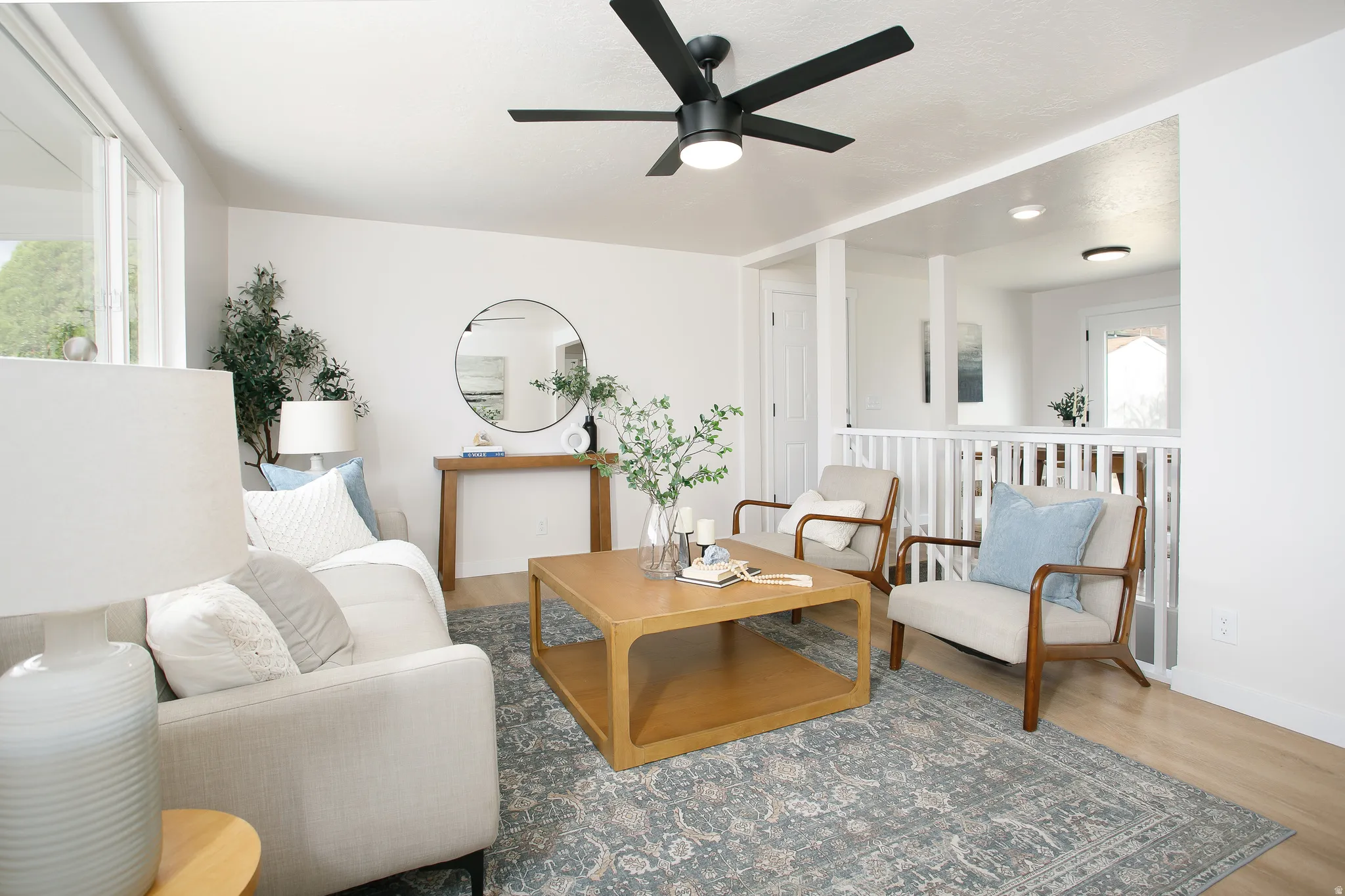 Recessed lighting, wood-finish flooring, and white walls