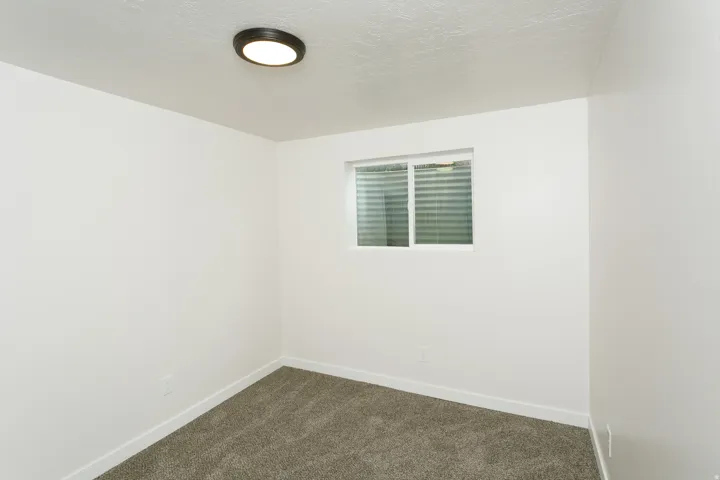 Wall-to-wall carpeting and neutral white walls