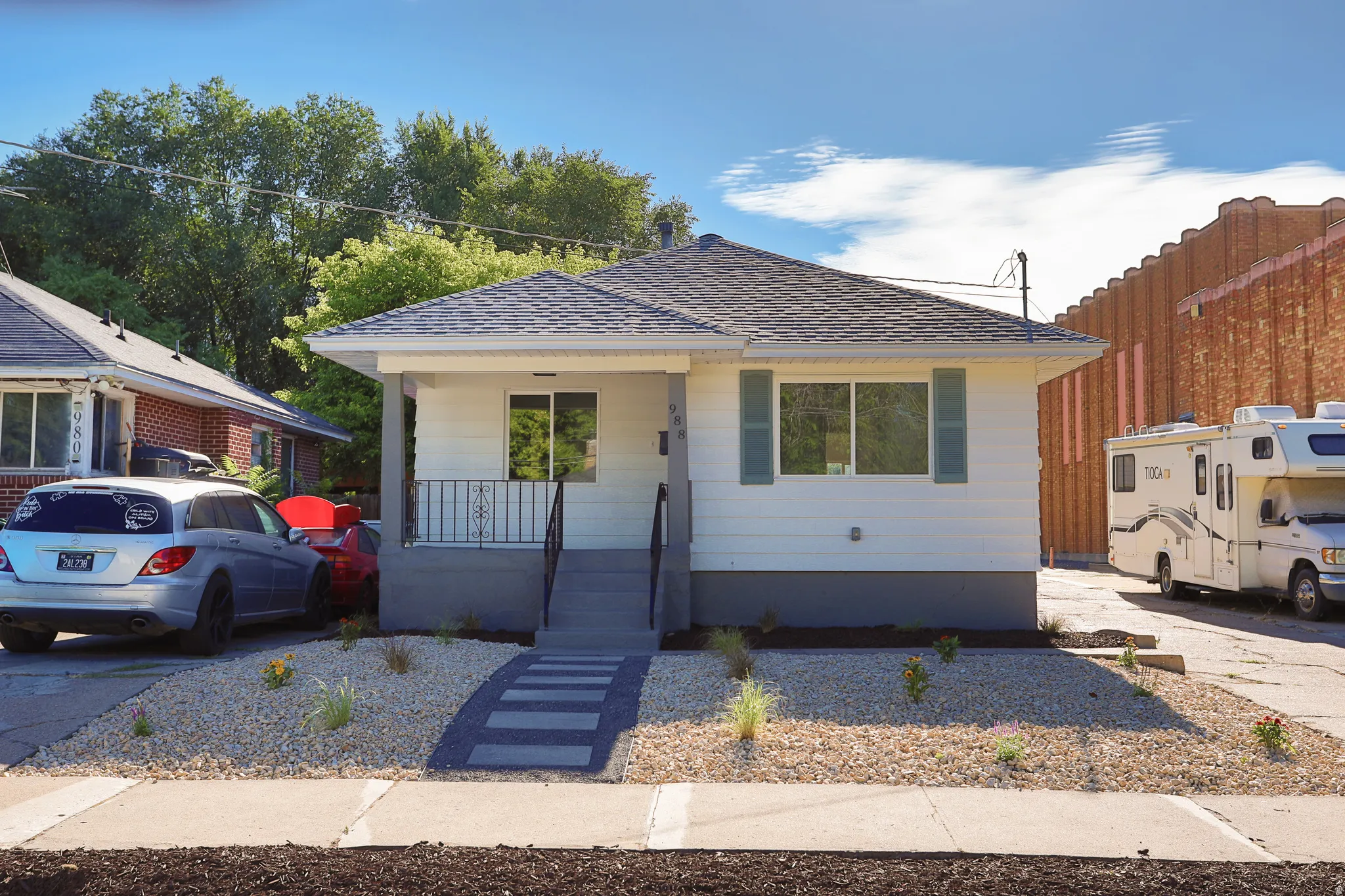 Light-colored siding exterior with a dark-toned foundation
