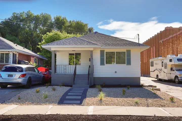 Light-colored siding exterior with a dark-toned foundation