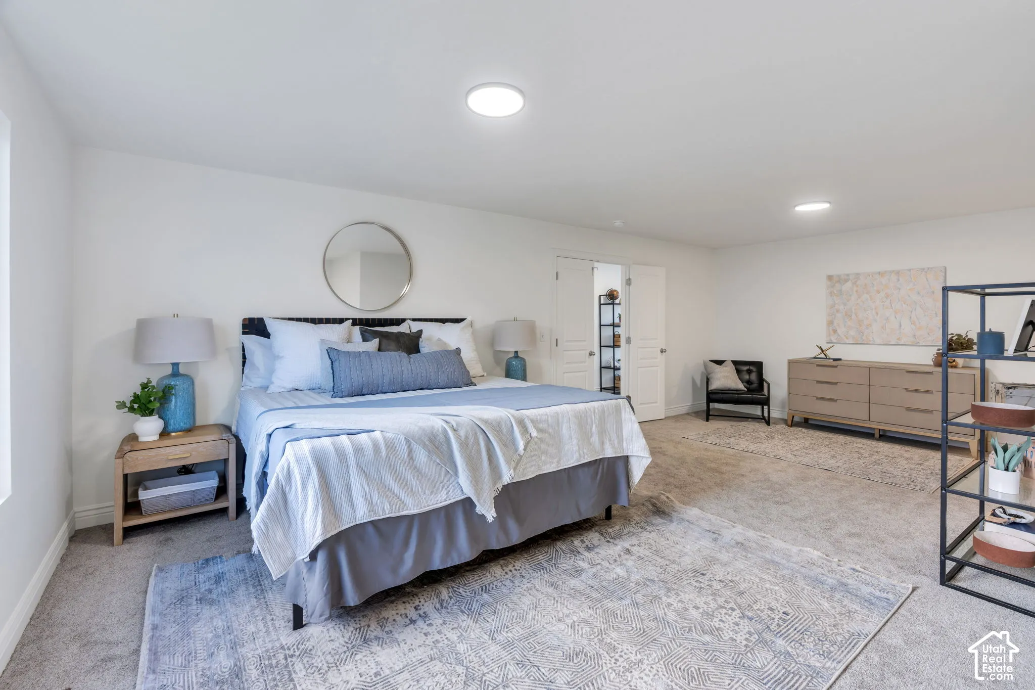 Spacious room featuring neutral carpeting, recessed ceiling lighting, and double-door entry