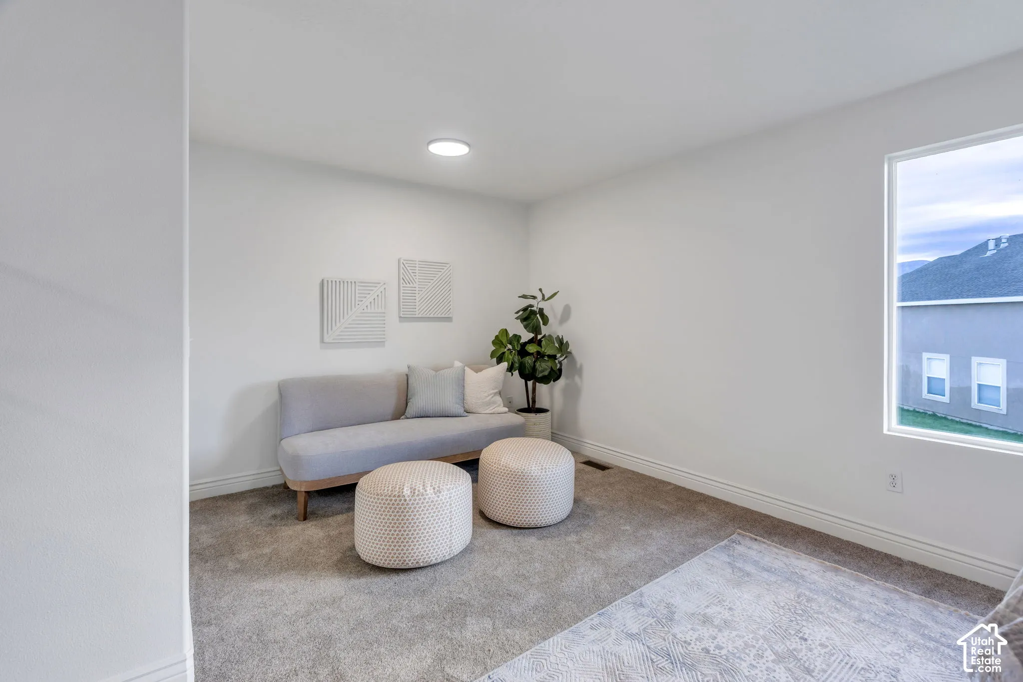 Recessed lighting, carpeted flooring, large window, white trim, and neutral wall tones