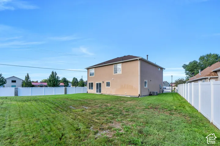 Expansive green lawn with a vinyl privacy fence