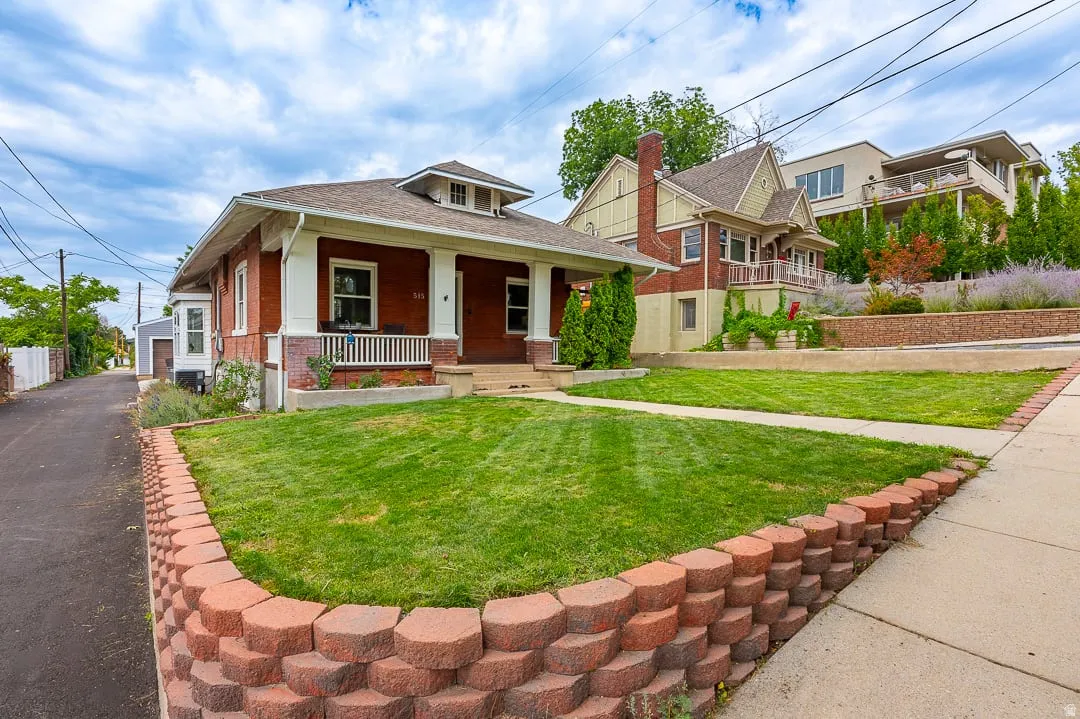 Brick exterior with a covered front porch featuring white railings