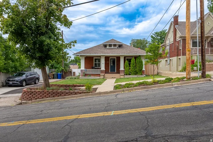 Brick exterior with gabled roofline and covered front porch