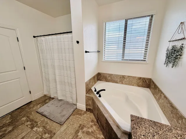 Built-in tub with stone-finish surround