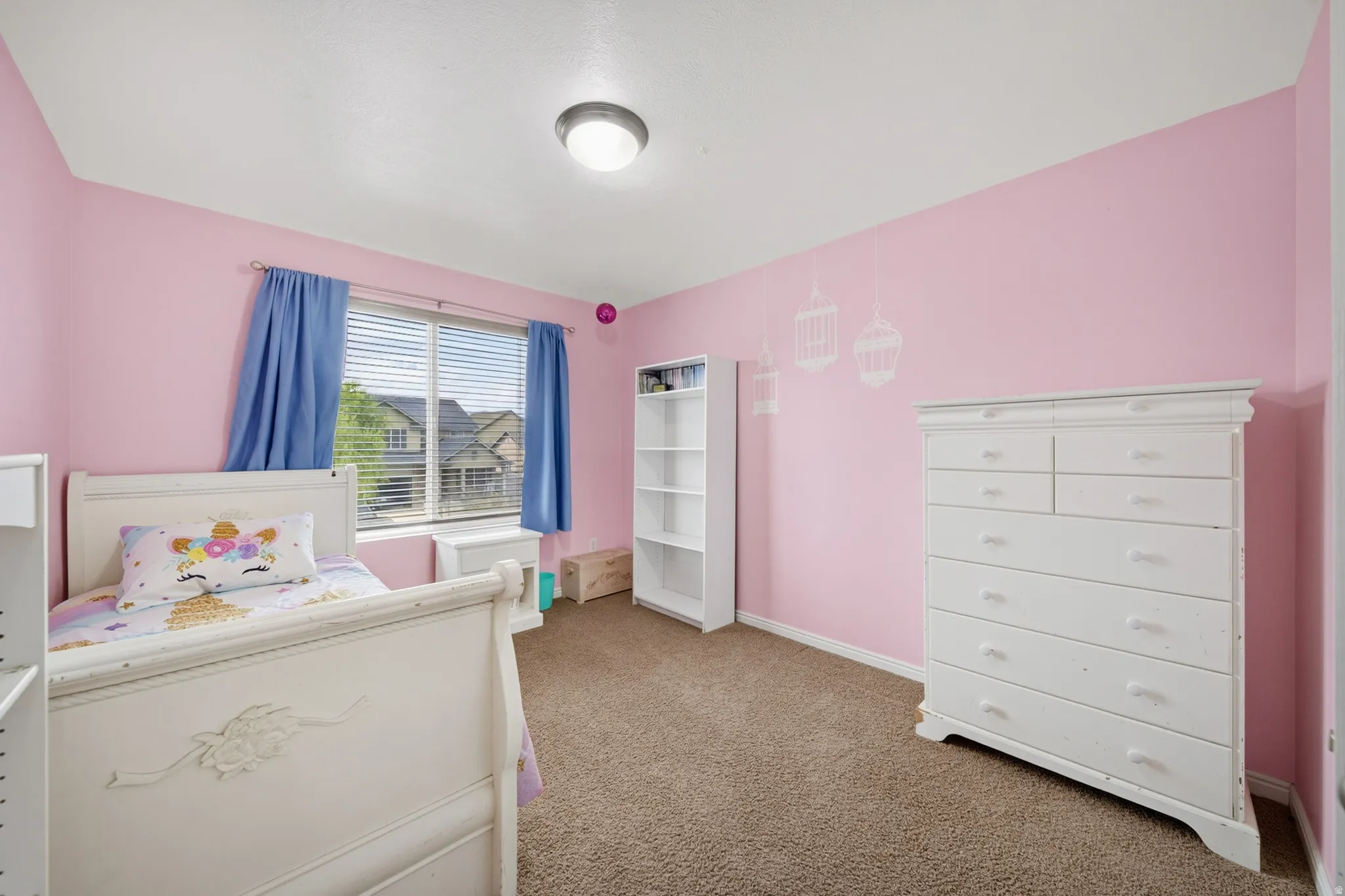 Carpeted room with a double-pane window, horizontal blinds, and a flush-mount ceiling light fixture