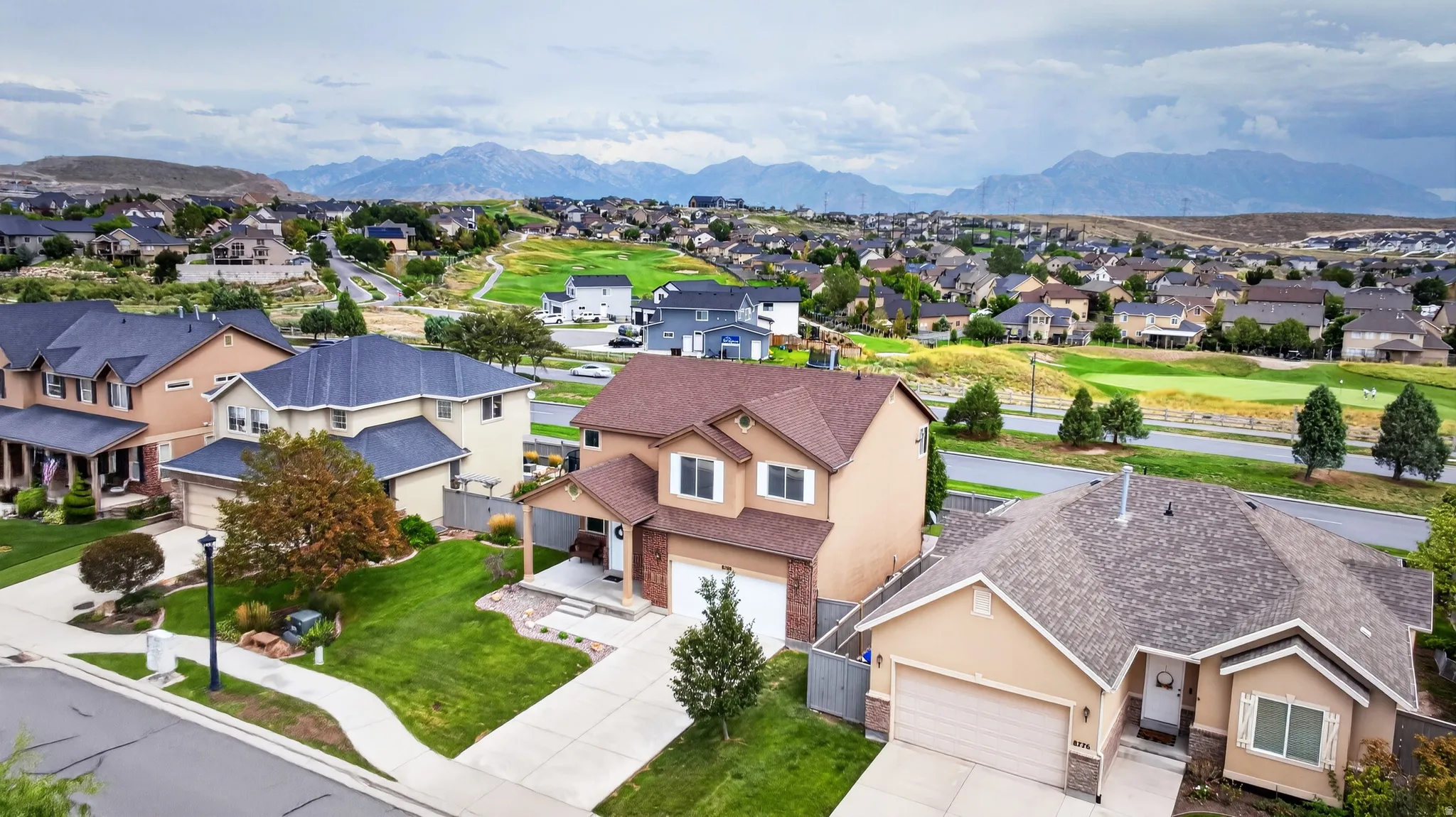 Residential community with mountain backdrop and golf course access