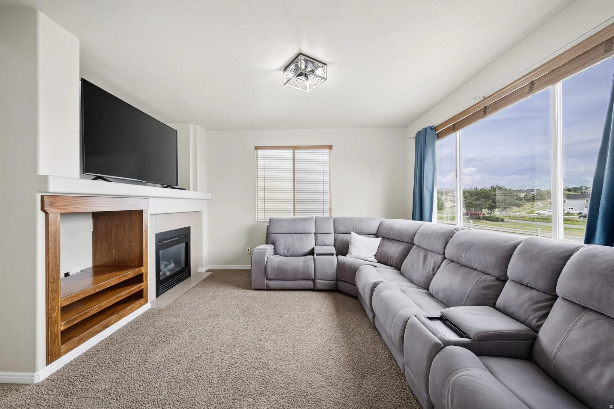 Built-in media center with wood-finish shelving, fireplace, and mantel