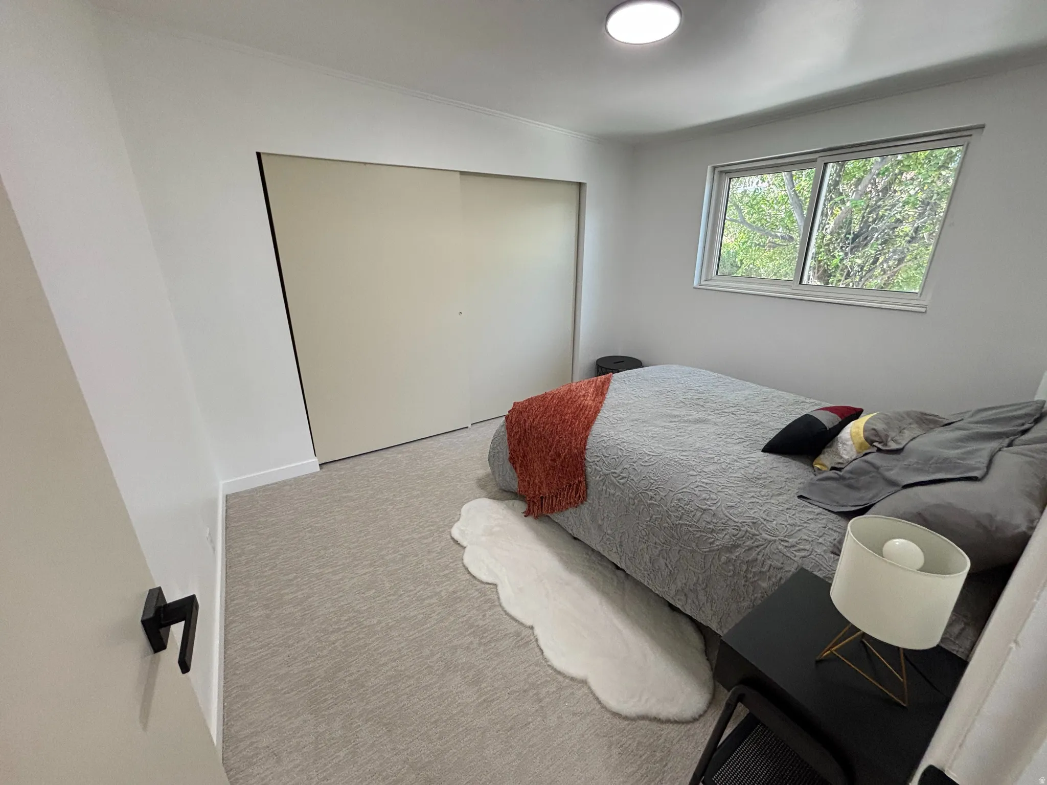 Recessed lighting, large window, wall-to-wall carpeting, and sliding closet doors